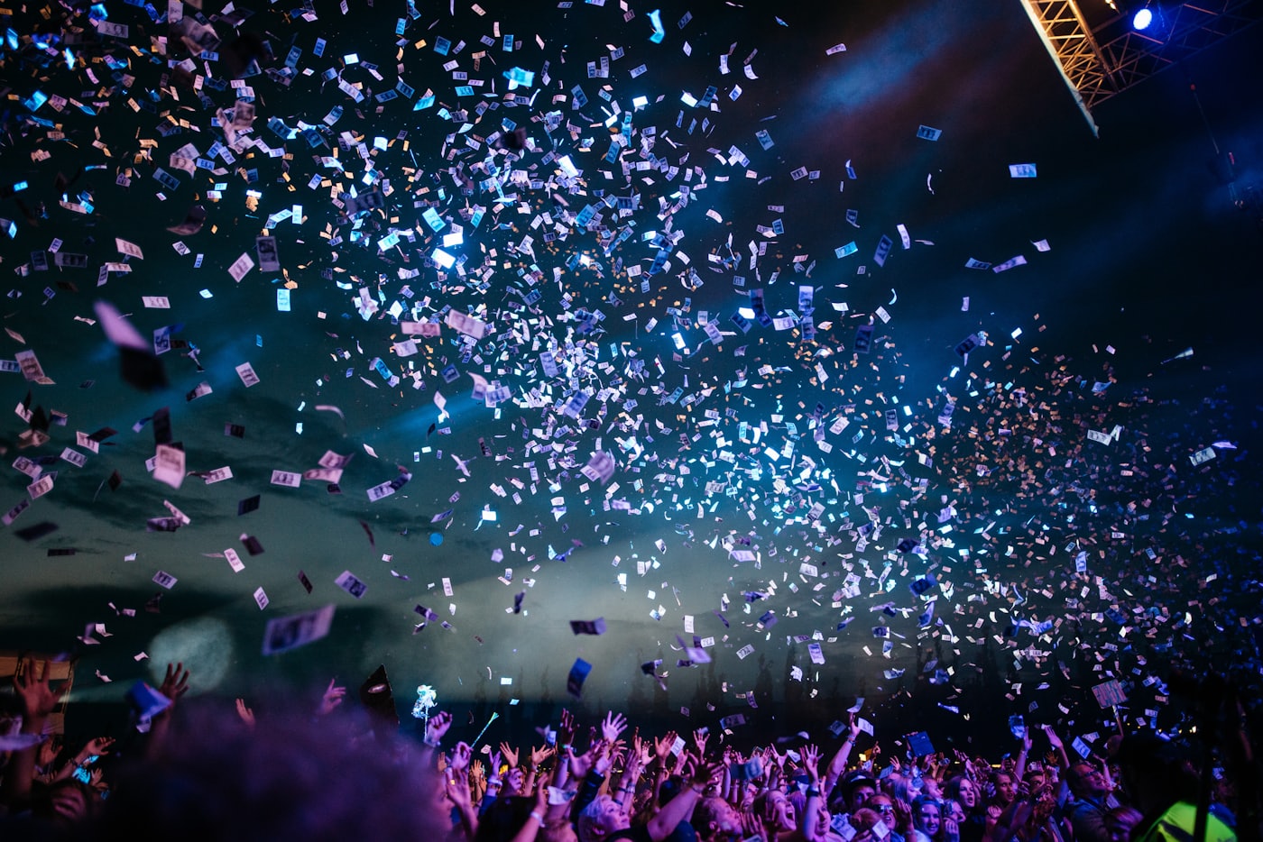 A decorated event ballroom with a stage, dramatic lighting and projected visuals across the walls